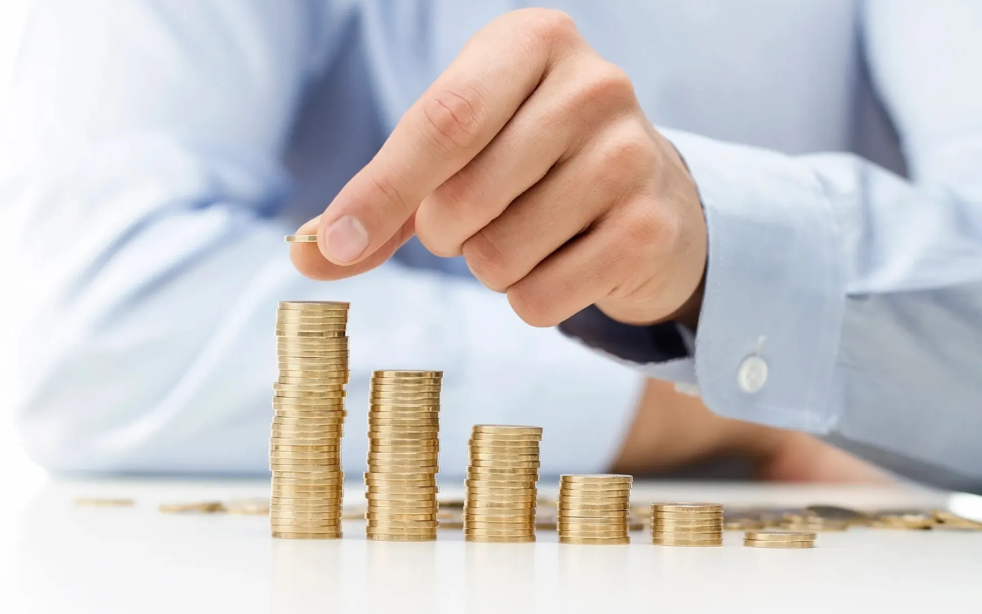 A photo of a man counting coins.