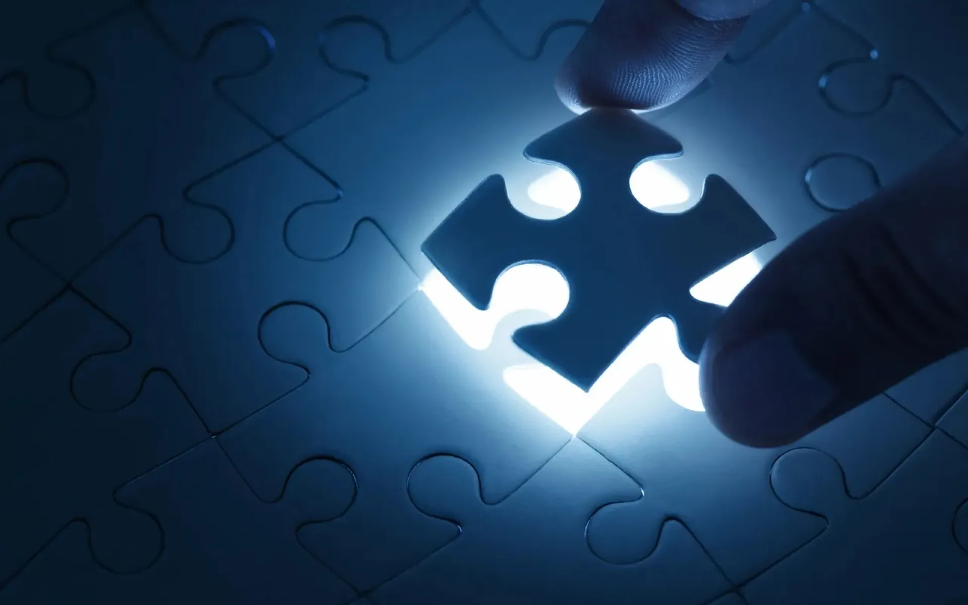 A photo of a puzzle piece being lifted.