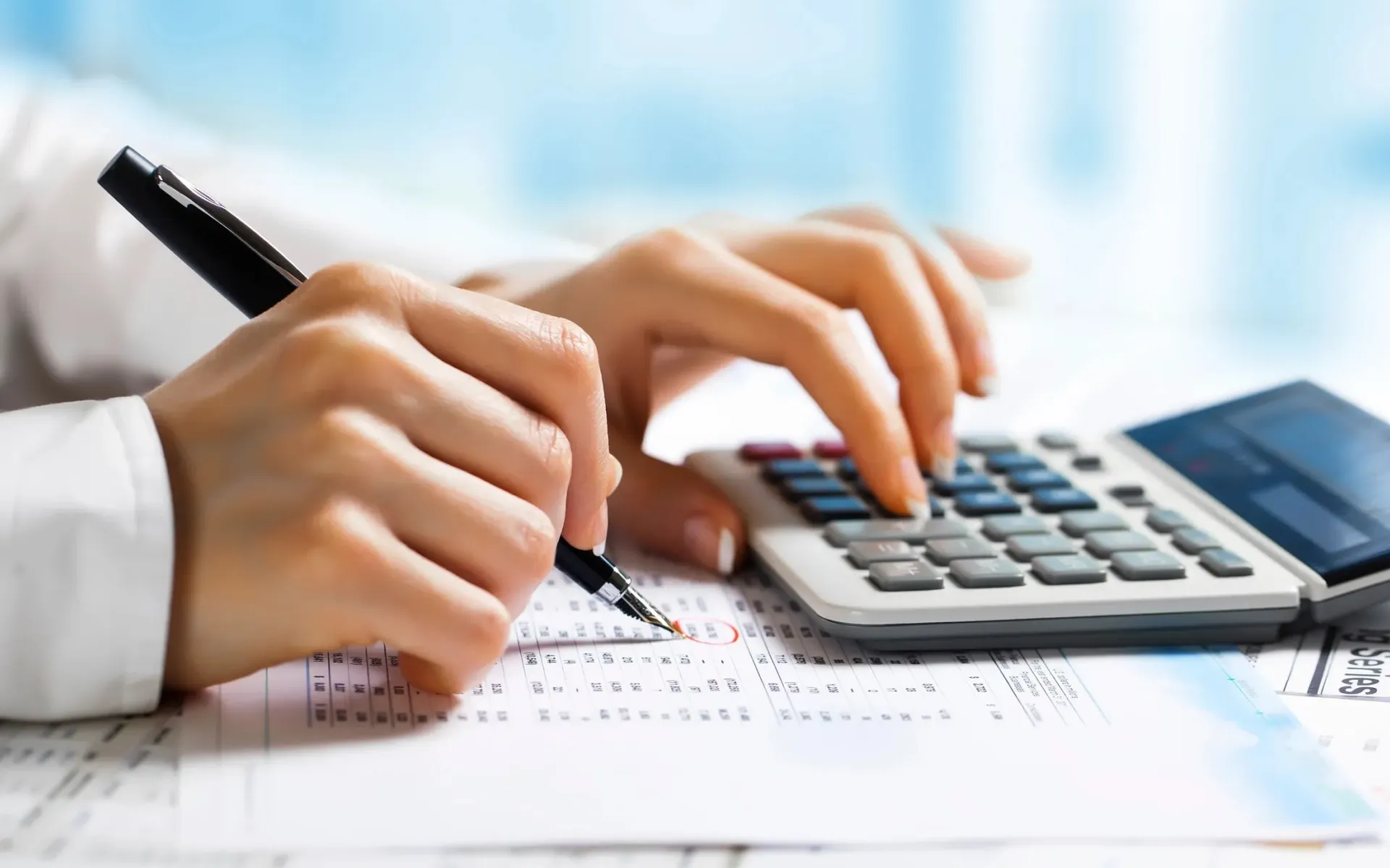 A photo of a man using a calculator.