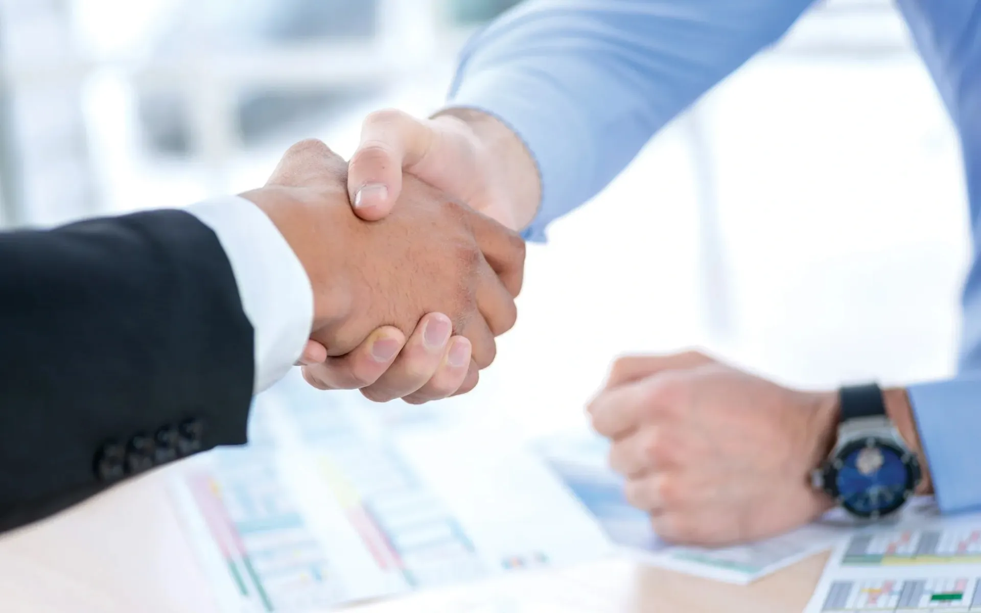 A photo of two men shaking hands.